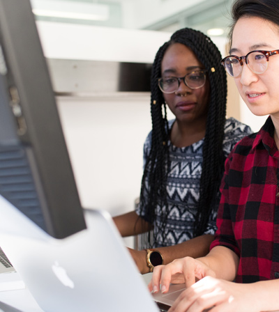 Two people working on a computer