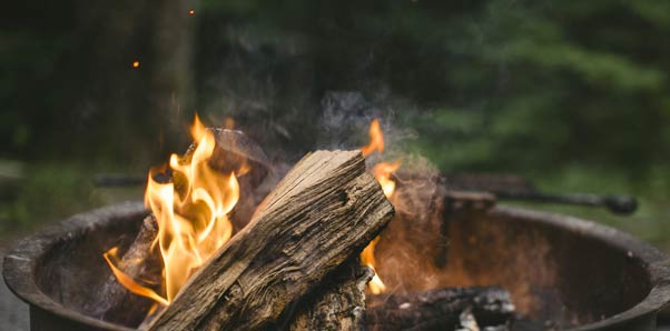 RV park fire pit with burning wood