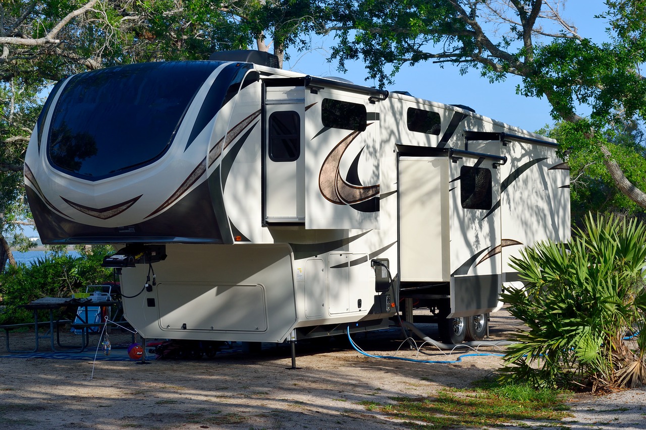 Camper parked on the beach in front of a lake